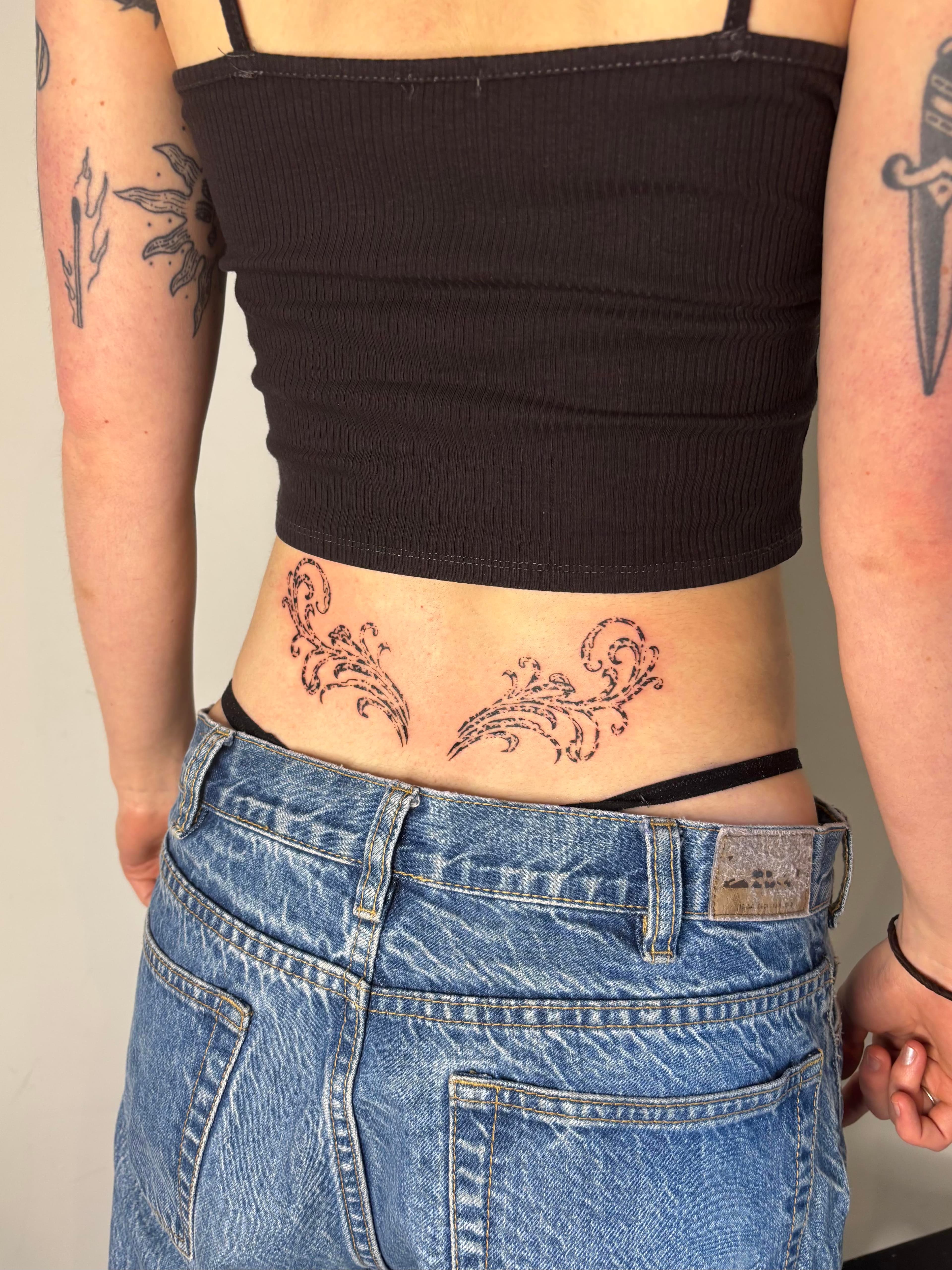 Ornamental fine line black tattoo